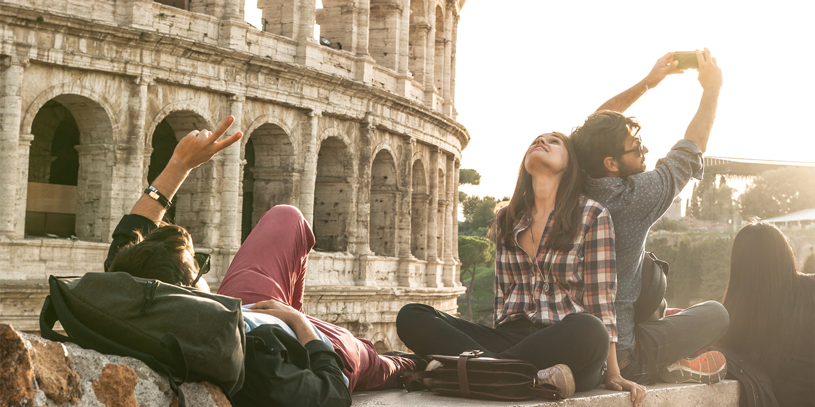 Jente sitter på kofferten ved innsjekking på hotell.